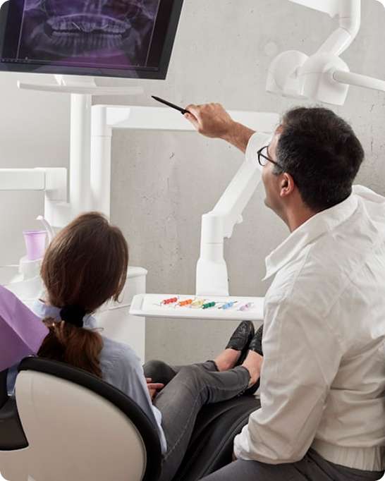 Dental implant specialist consulting with patient