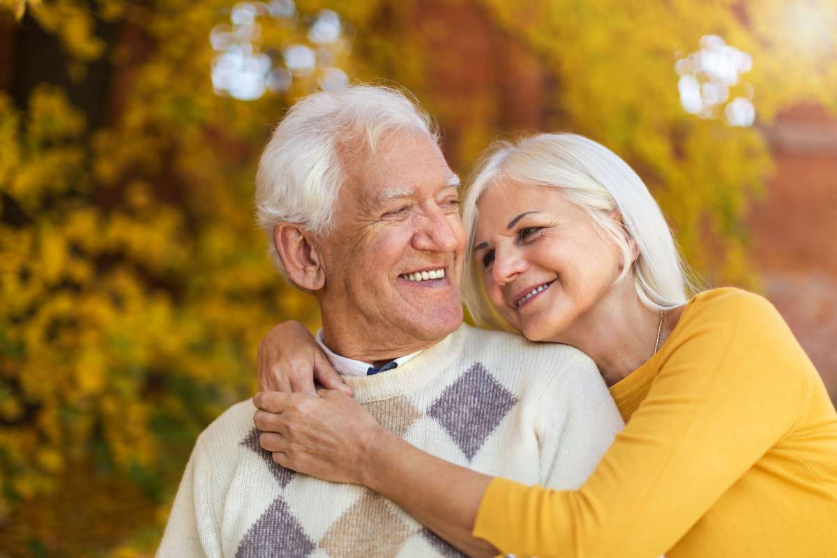 Couple smiling confidently after All-on-X treatment
